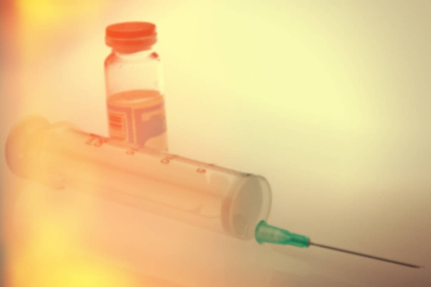 capsules and syringe blur background - Photo, Image