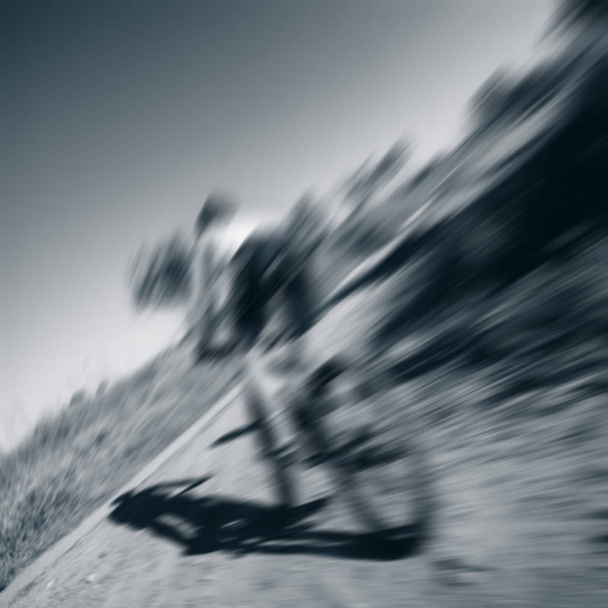 blurred background, racing cyclist rides on rough terrain - Foto, Imagen