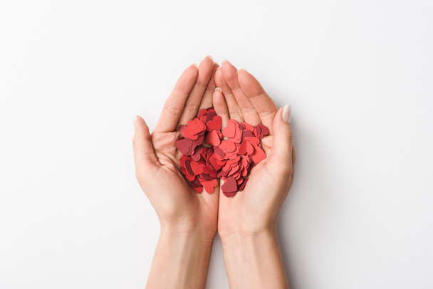 Cropped view of woman holding paper hearts on white background  - Photo, Image