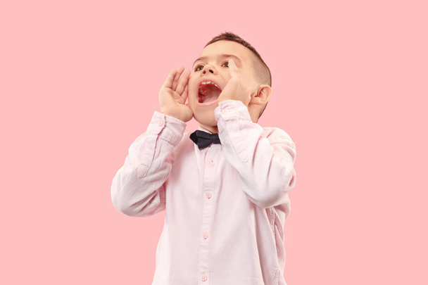 Isolated on pink young casual boy shouting at studio - Photo, image