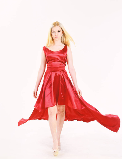Dress rent service, fashion industry. Dress rent concept. Woman wears elegant evening red dress, white background. Lady rented fashionable dress for visiting event.Girl blonde posing in dress. - Photo, image