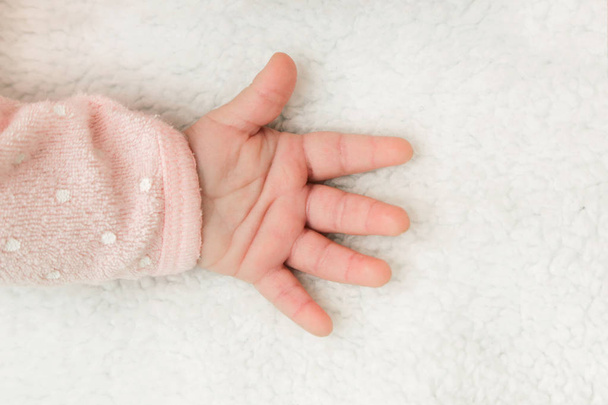 Newborn baby hand on the blanket - Фото, изображение