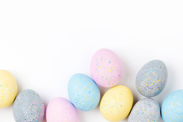 Background with pale pink, blue, yellow and gray Easter eggs. Compositions in pastel colors.  Easter concept - Foto, afbeelding