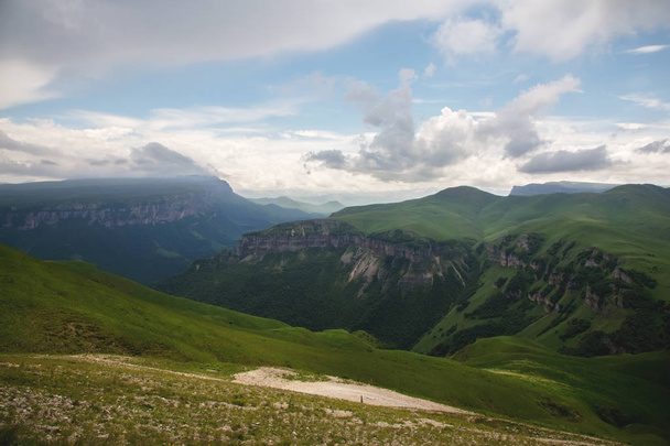Dramatic landscape of a green valley at the foot of the Inal Plateau in the North Caucasus - Foto, immagini