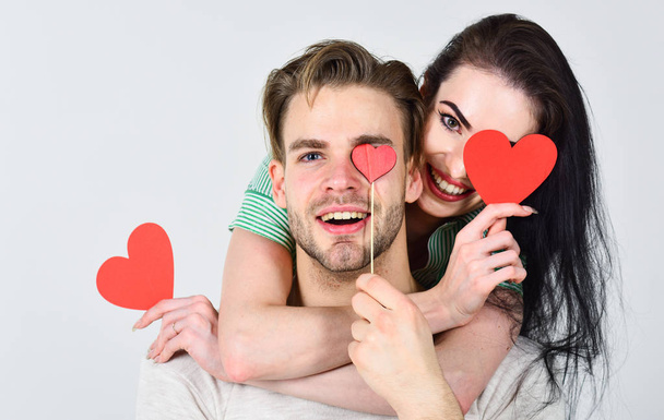 Man and woman couple in love hug and hold red heart valentines cards close up. Valentines day concept. Romantic ideas celebrate valentines day. Man and pretty girl in love. Valentines day and love - 写真・画像