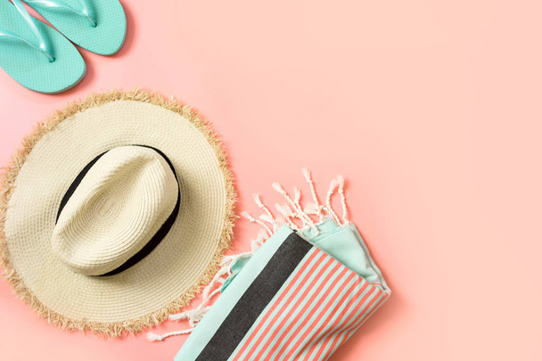 Female outfit for beach. Straw sunhat and beach slaps on punchy pink with space for text. Summer tropical concept. - Fotoğraf, Görsel