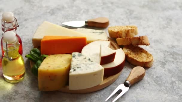 Various types of cheese served on rustic wooden board - Footage, Video