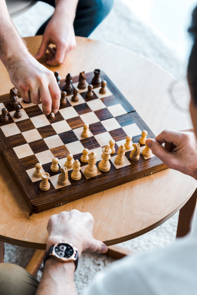 selective focus of seniors playing chess at home - Fotó, kép