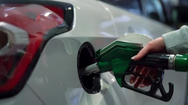 Woman fills petrol into her car at a gas station closeup - Metraje, vídeo