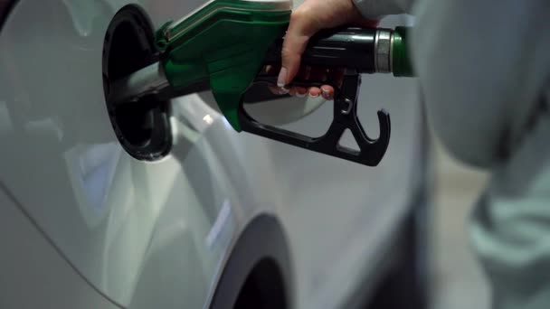 Woman fills petrol into her car at a gas station closeup - Footage, Video