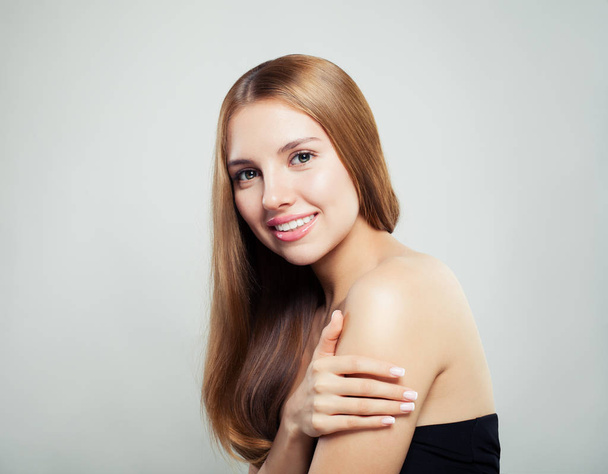 Happy girl with natural healthy hair and clear skin on white background. Perfect woman face - Fotó, kép