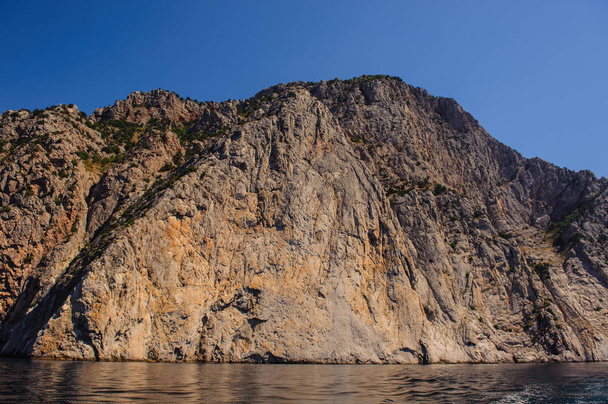 rocks, mountains and the sea on a sunny day - Фото, зображення