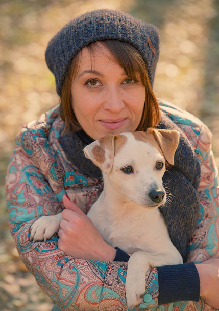 portrait of a woman with a dog in the park, the age of 40 - 写真・画像