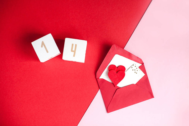 Valentine's day concept. Valentine, hearts, wooden cubes with numbers on a pink background. Holidays. - Foto, imagen