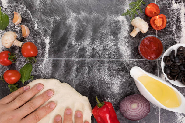 Preparing pizza dough. Fresh ingredients for cooking pizza on a stone table. Food background. Food concept. Top view. Space for text - Photo, Image
