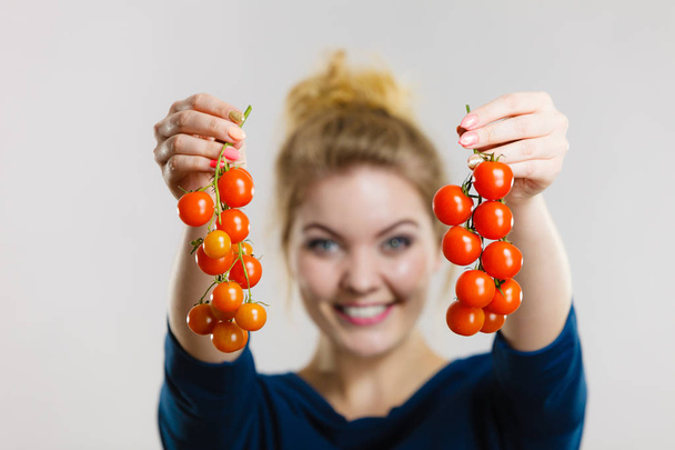 Organic vegetables and food concept. Happy positive smiling woman holding fresh cherry tomatoes - Fotoğraf, Görsel