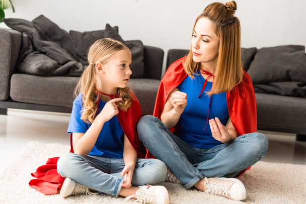 daughter and mother sitting on floor and talking at home - Photo, Image
