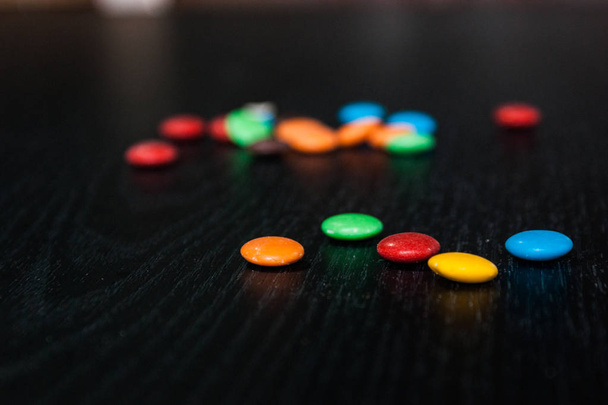 some colorful candies over a wooden table - Photo, Image