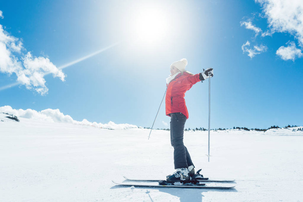 Woman enjoying her winter vacation on ski - Фото, изображение