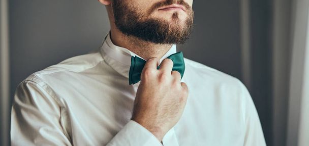 hombre de negocios que se pone corbata de lazo, ropa de mariposa hombre, novio preparándose en la mañana antes de la ceremonia de la boda. Moda de hombres - Foto, imagen