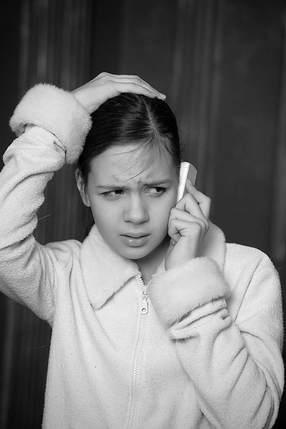 12 year old girl with a distressed view talking on the phone - Photo, Image