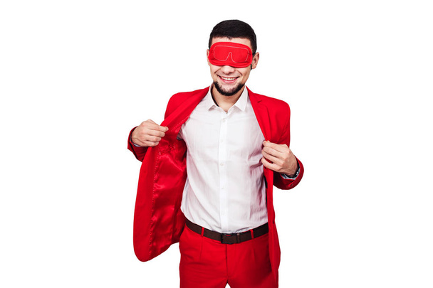 jonge zakenman, is afhankelijk van geluk, fortuin. bebaarde man in een rood pak met een rode blinddoek. geïsoleerd op wit - Foto, afbeelding