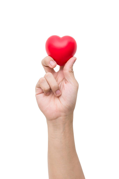 Pallina cardiaca rossa: sfera di schiuma antistress la forma del cuore rosso sulla mano della donna isolata su sfondo bianco con percorso di ritaglio
 - Foto, immagini