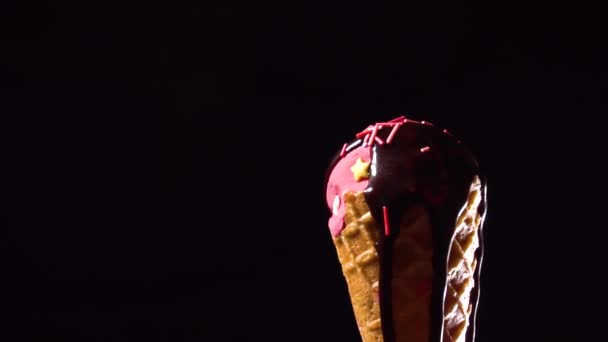 Rotating ice cream with chocolate topping and falling sugar decoration - Кадри, відео