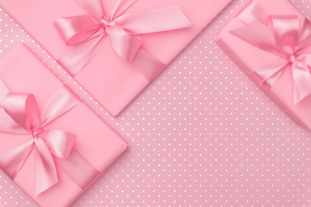 Gift box with pink ribbon bow on pink speckled background top view. Holiday concept, birthday gift, 8 march or Women day, gift box presents holiday Mothers day. Greeting card with copy space. Flat Lay - Photo, Image