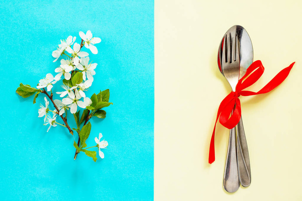 Spring flowers and cutlery. Minimal easter concept. Flat lay, top view background. - Photo, Image
