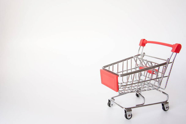 Red Shopping cart or supermarket cart on white background with copy space - Fotografie, Obrázek