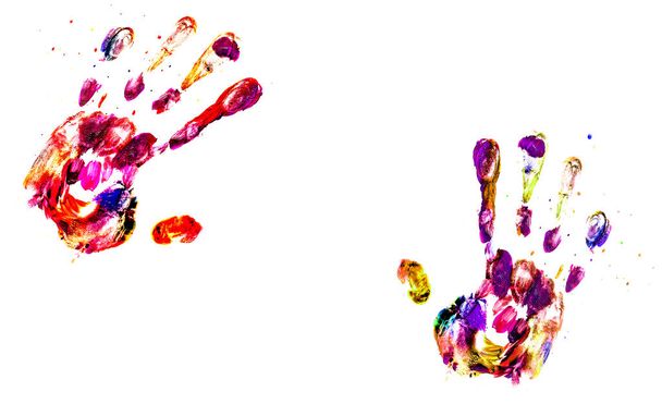 The imprint of two hands of colored acrylic paints on a white background - Foto, imagen