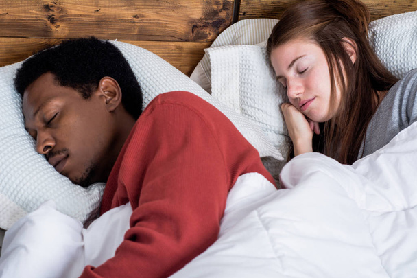 Close-up of Multiracial couple sleeping in a comfortable bed at home.  - Fotoğraf, Görsel
