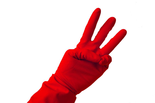 Hand in de latex handschoen weergegeven: nummer drie - Foto, afbeelding