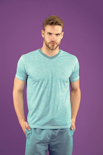 Man in tshirt and shorts on violet background. Guy in blue casual clothes. Macho in active wear for workout or training on purple background. Sport fashion style and trend. Fitness and gym activity - Photo, Image