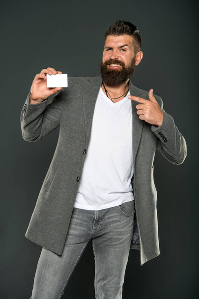 Plastic bank card. Which bank card easy to get. Easy shopping. Credit card gives you freedom and confidence. Man bearded hipster hold plastic blank card. Banking and credit concept. Easy money credit - 写真・画像