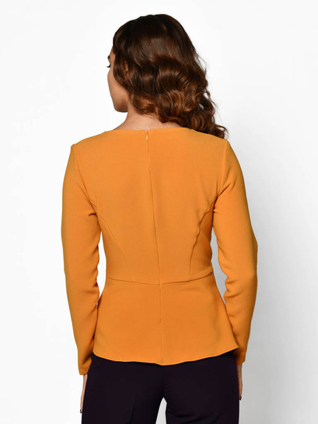 Young beautiful woman posing in new casual yellow orange blouse sweater backside rear view - Fotó, kép