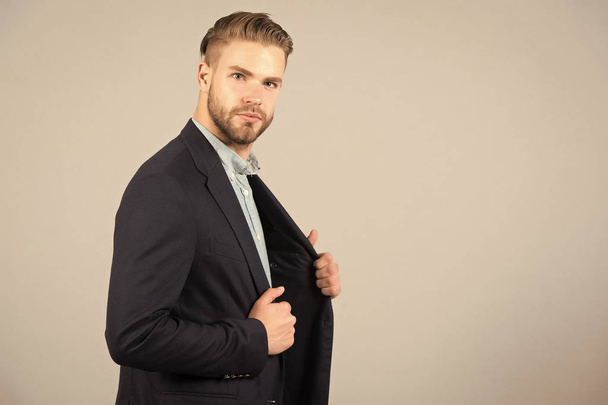 Businessman with stylish hair in formal suit. Man with beard and mustache on unshaven face. Beard grooming and hair care in barbershop. Business fashion or style and trend concept, copy space - 写真・画像