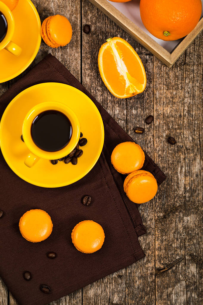 Orange French Macarons with Dark Chocolate and Coffee Filling. Selective focus. - Foto, Imagen