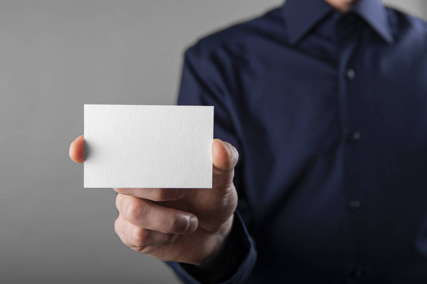 A man holding white business card - Фото, изображение