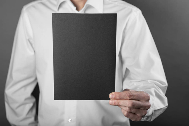 A man holding black booklet - Foto, immagini
