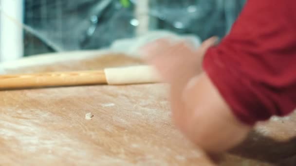 Cook making cake from dough with rolling pin. Cooking pizza at bakery - Video, Çekim