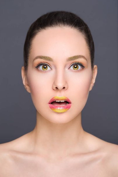 Brunette makeup beauty with shocked facial expression with metallic lipstick effect. - Foto, Imagen