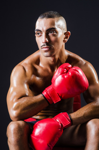 Boxer with red gloves in dark room - Foto, Bild
