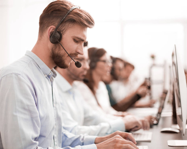 handsome man with a headset working in a call center - Zdjęcie, obraz
