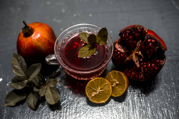 Close up of herbal tea of pomegranate with lemons  - Foto, imagen
