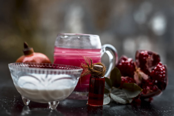 Close up of pomegranate juice and essence with milk on wooden surface - Foto, immagini