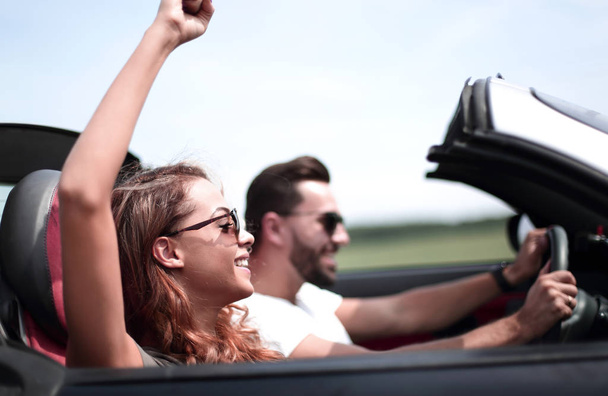 close up.a young woman with her boyfriend in a convertible car - Φωτογραφία, εικόνα