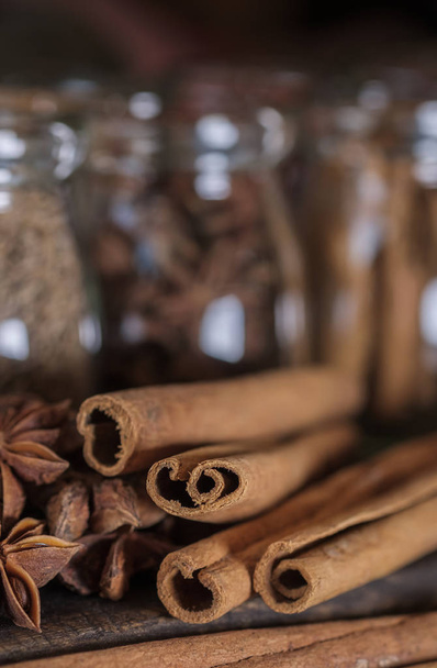 Cinnamon sticks on the dark wood table. - Φωτογραφία, εικόνα