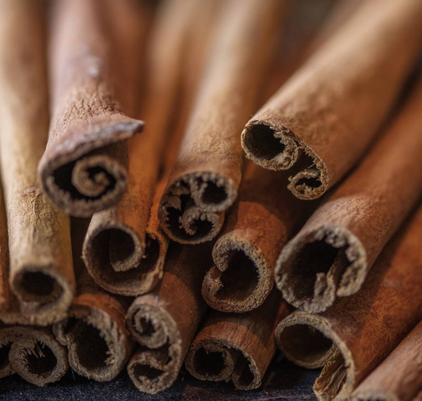 Cinnamon sticks on the dark wood table. - Foto, afbeelding